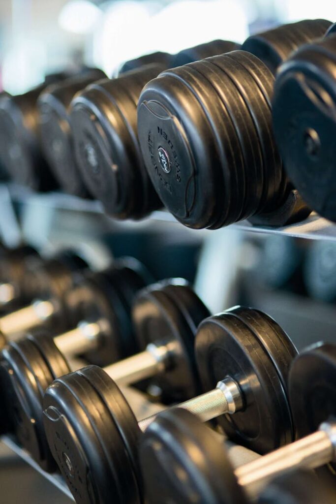 Crafting Captivating Headlines: Your awesome post title goes here Close-up view of black dumbbells neatly arranged on a rack in a gym.